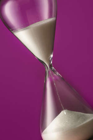 Hourglass on color background. Time management concept