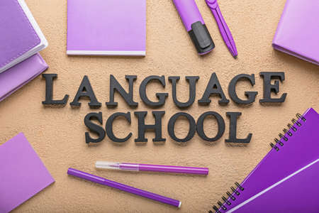 Composition with stationery and text LANGUAGE SCHOOL on color backgroundの写真素材