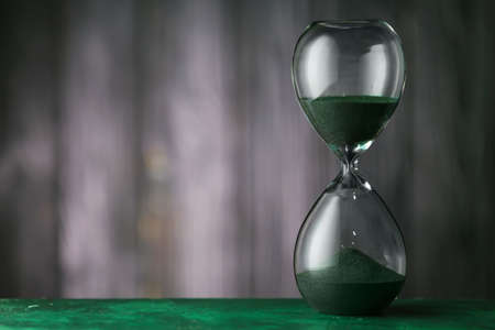 Hourglass on dark background. Time management concept