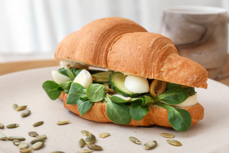 Tasty croissant sandwich on plate, closeupの写真素材