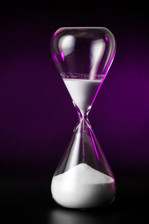 Hourglass on dark background. Time management conceptの写真素材