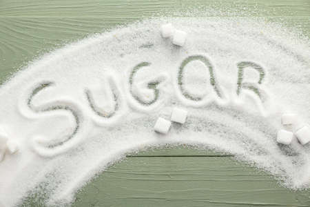 White sugar on color wooden backgroundの写真素材