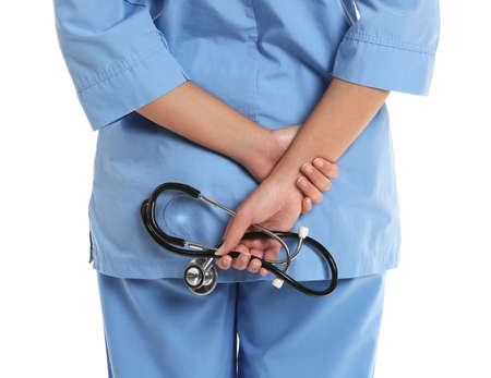 Young African-American nurse with stethoscope on white backgroundの写真素材
