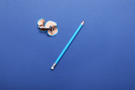 Ordinary pencils and shavings on color backgroundの写真素材
