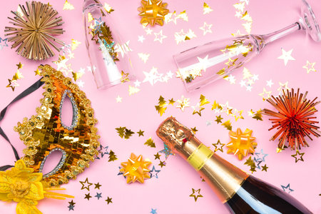 Glasses and bottle of tasty champagne with party decor on color backgroundの写真素材