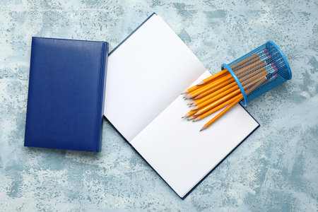 Ordinary pencils and notebooks on color backgroundの写真素材