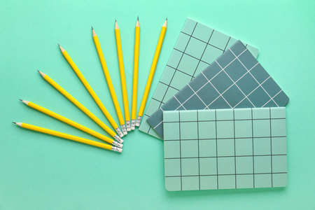 Ordinary pencils and notebooks on color backgroundの写真素材
