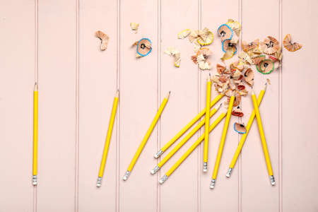 Ordinary pencils and shavings on color wooden backgroundの写真素材