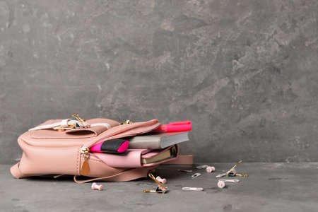 Backpack with set of school supplies on table against gray backgroundの写真素材