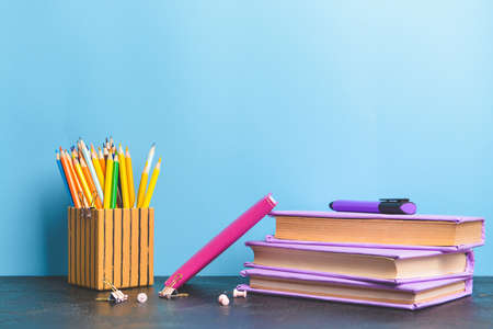 Set of school supplies on table against color backgroundの写真素材