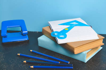Set of school supplies on table against color backgroundの写真素材