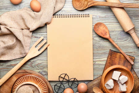 Cook book with products on wooden backgroundの写真素材