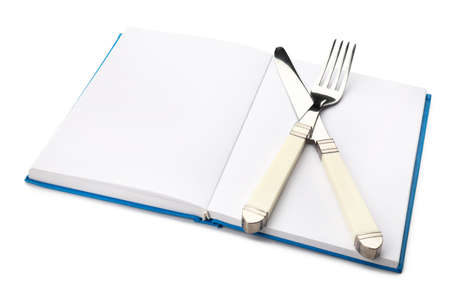 Cook book with cutlery on white backgroundの写真素材