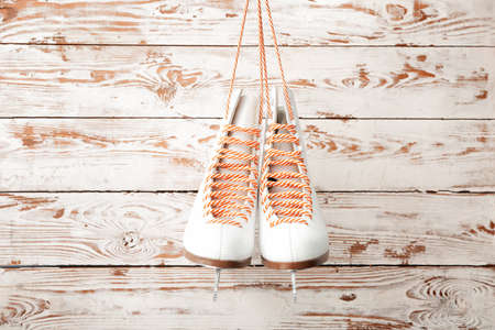 Ice skate shoes on white wooden backgroundの写真素材
