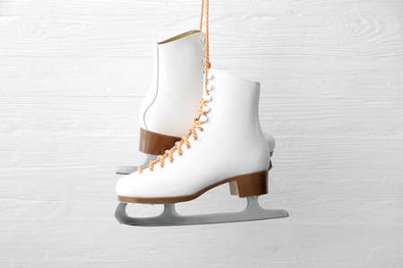 Ice skate shoes on white wooden backgroundの写真素材