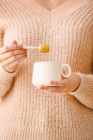 Woman drinking tea with honey, closeupの写真素材