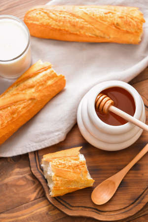 Sweet honey, milk and bread on tableの写真素材