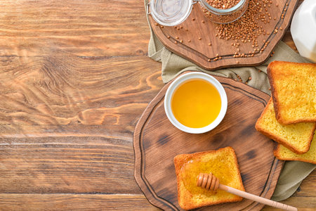 Sweet honey and toasted bread on table