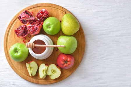 Sweet honey and fruits on tableの写真素材