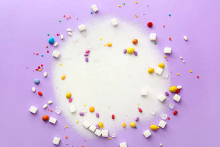 Sweet sugar and candies on color backgroundの写真素材