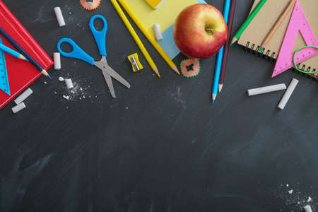 Set of school stationery on blackboardの写真素材