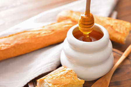 Sweet honey and bread on tableの写真素材