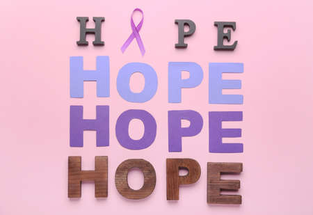 Violet ribbon and words HOPE on color background. Domestic violence conceptの写真素材