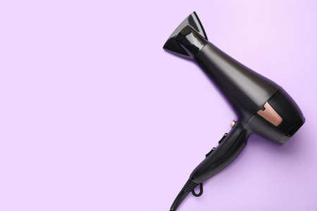 Modern hair dryer on color backgroundの写真素材