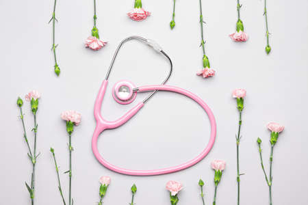 Stethoscope with flowers on white backgroundの写真素材