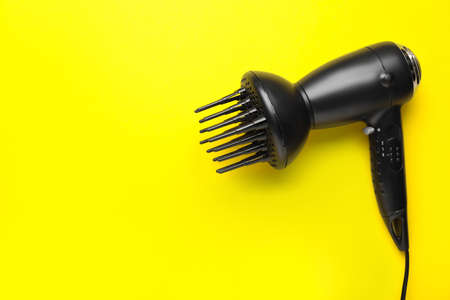 Modern hair dryer on color backgroundの写真素材