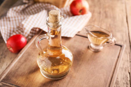 Apple cider vinegar on wooden tableの写真素材