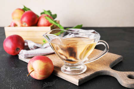 Gravy boat of apple cider vinegar on table