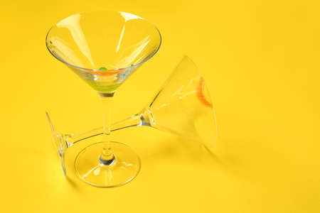 Dirty empty cocktail glasses on color backgroundの写真素材