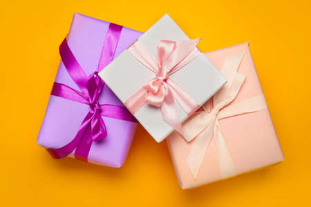 Beautiful gift boxes on color background