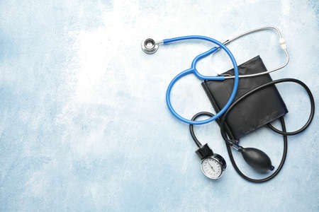 Stethoscope with sphygmomanometer on color backgroundの写真素材