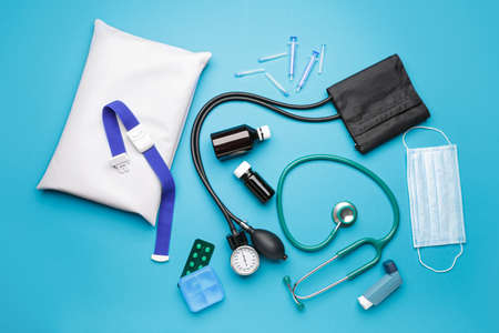 First aid kit on color background