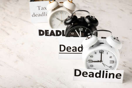 Alarm clocks with words DEADLINE on white backgroundの写真素材