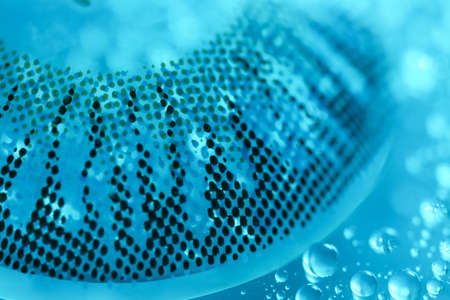 Contact lens and water drops on color background, closeupの写真素材