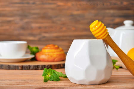 Jar with tasty honey on wooden tableの写真素材