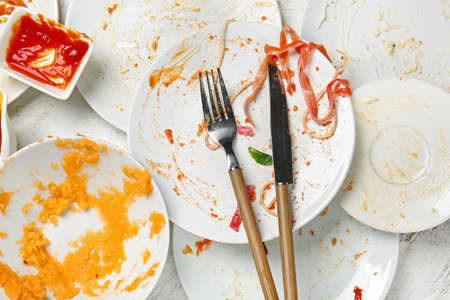 Dirty empty tableware on light backgroundの写真素材