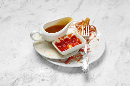 Dirty empty tableware on light background