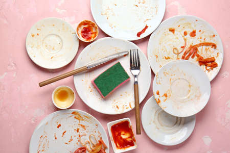 Dirty tableware on color backgroundの写真素材