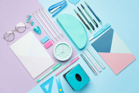 Set of school supplies with clock on color backgroundの写真素材