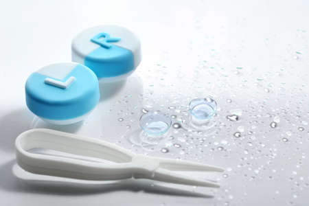Contact lenses with tweezers and case on white backgroundの写真素材