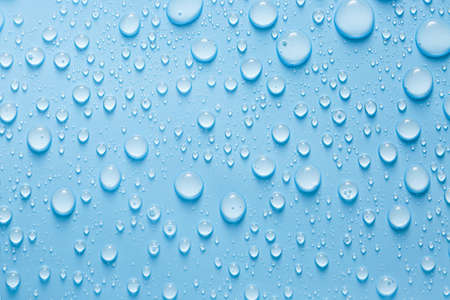 Drops of water on color background