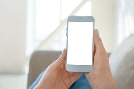 Young woman with mobile phone at home