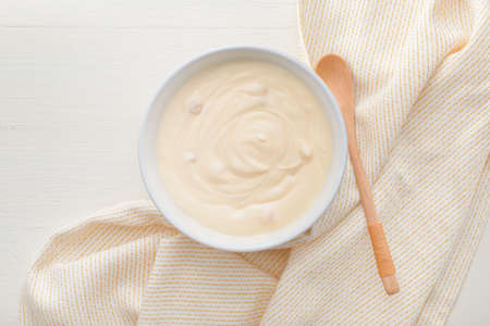Bowl with tasty yogurt on tableの写真素材