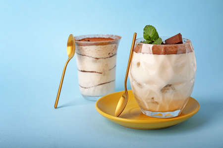 Tasty tiramisu on color background