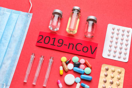 Protective mask and medicines for Coronavirus on color background