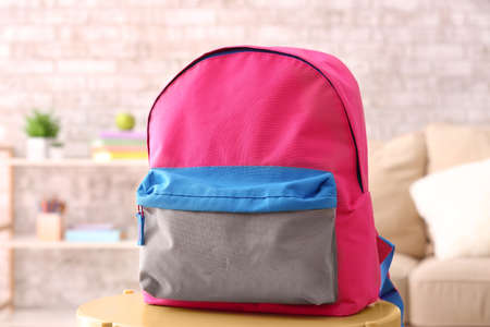 School backpack on table in roomの写真素材